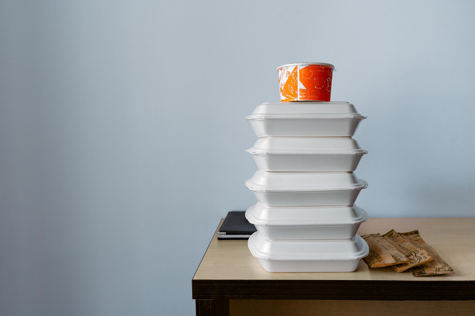 Stack of prepared meal boxes for office lunch