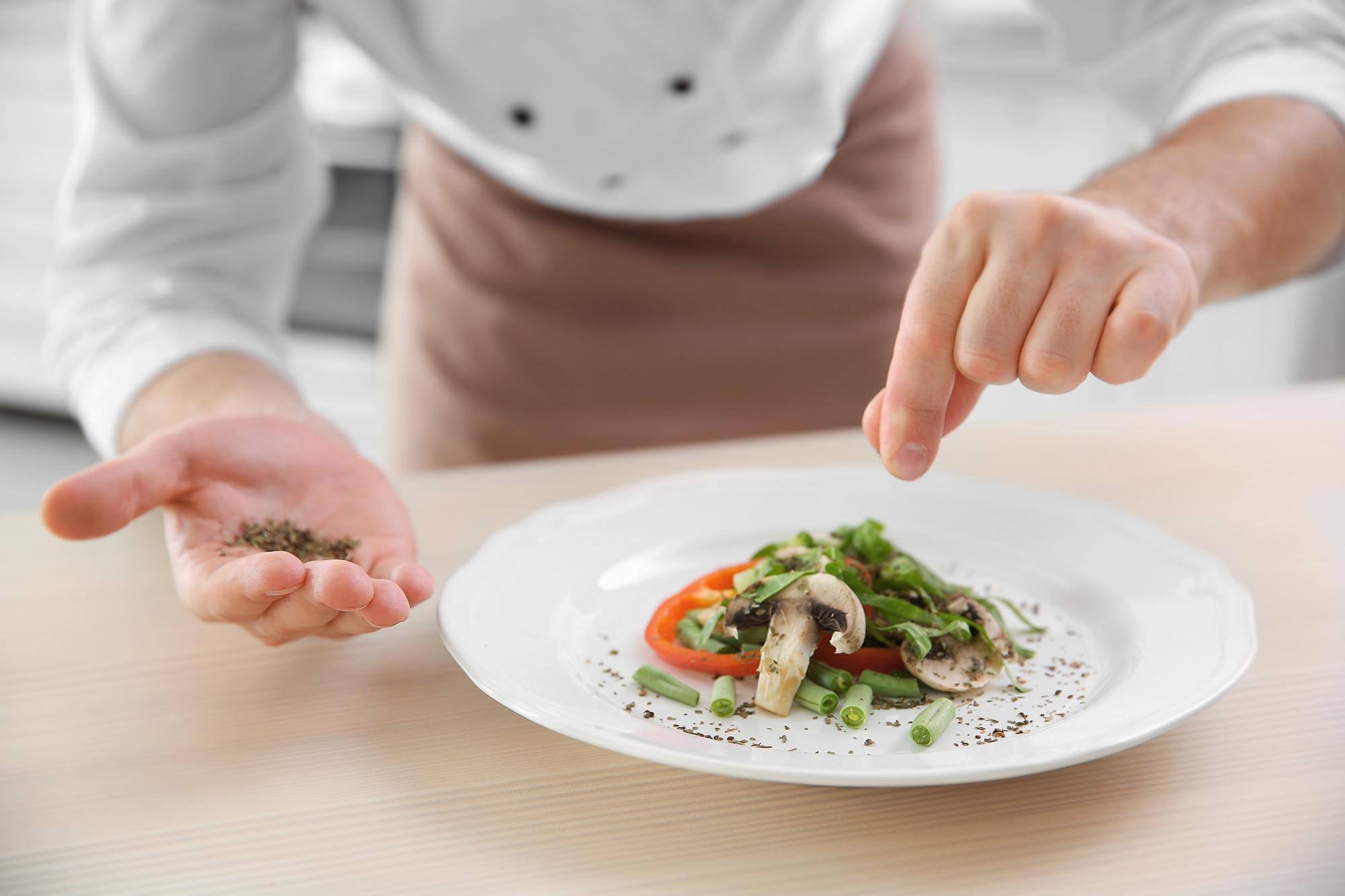 Chef preparing a quick plated dish on a modern counter